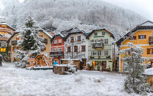 Old town buildings covered in snow during winter, Hallstatt.