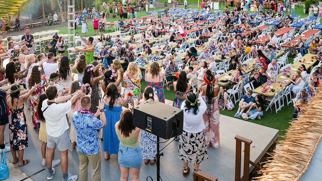 Guests and staff participating in pre-show activities at Mauka Warriors Luau.