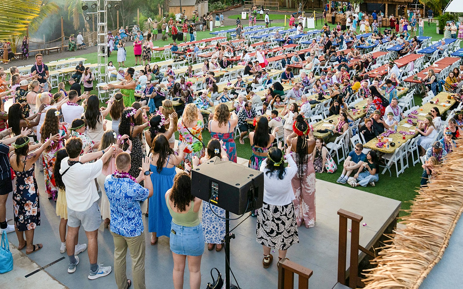 Guests and staff gathered together engaged in pre show activities at Mauka Warriors Luau community