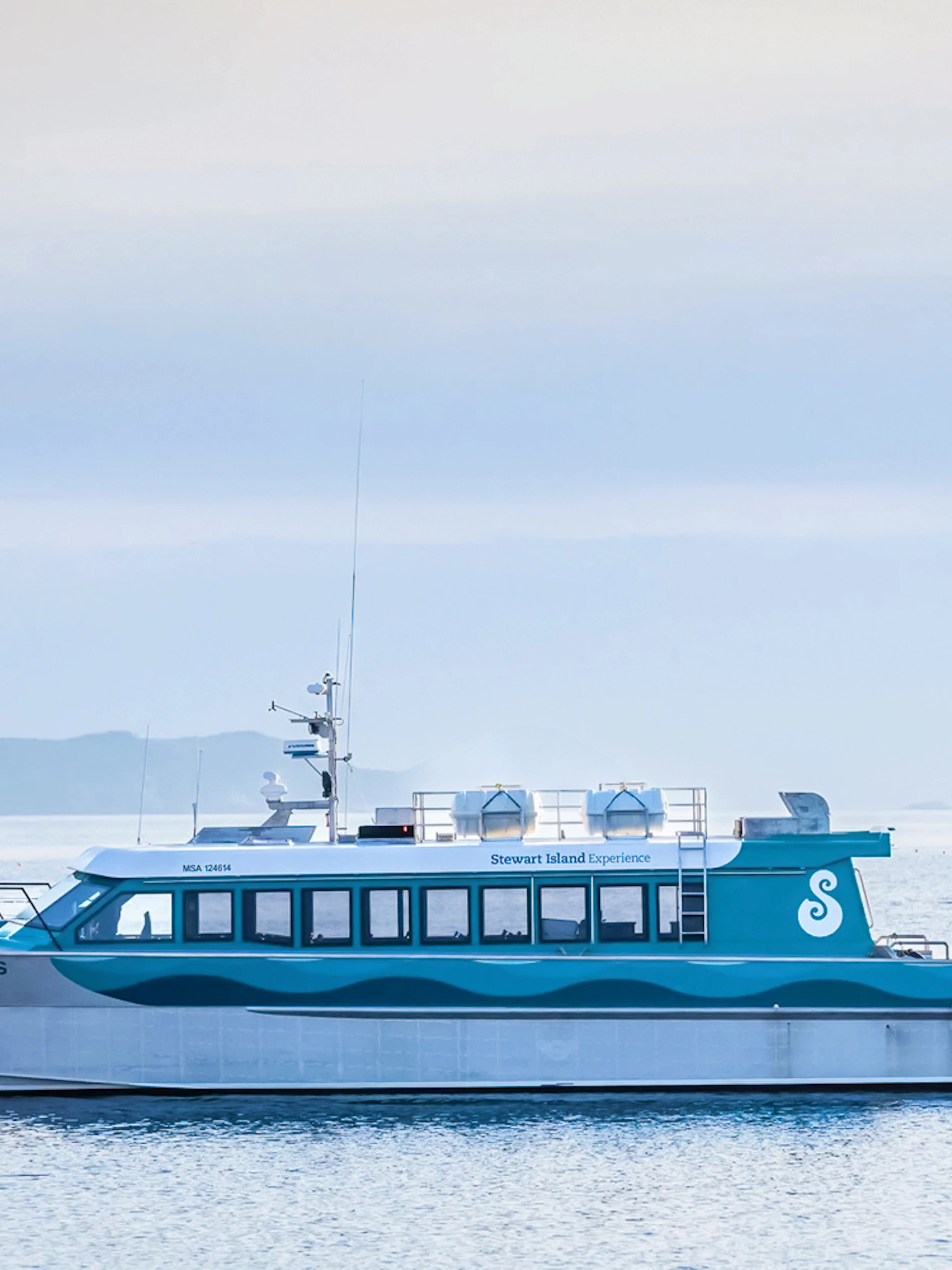 Stewart Island Ferry docked with distant islands in the background.