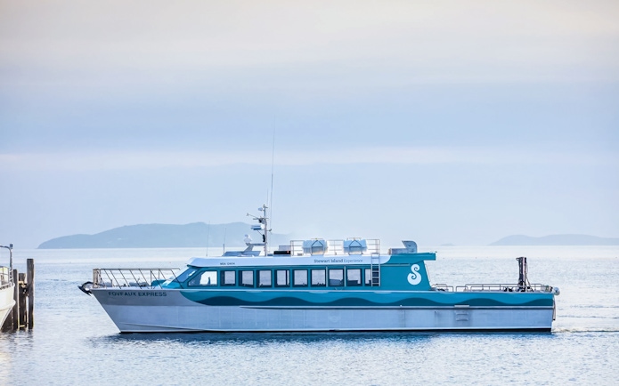 Stewart Island Ferry docked with distant islands in the background.