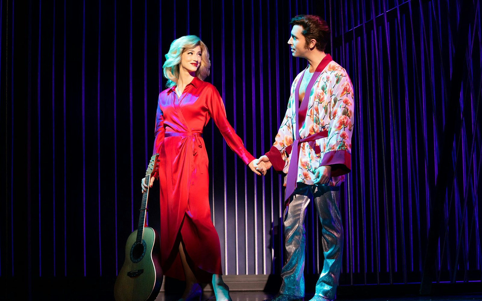 Performers on stage in "A Beautiful Noise: The Neil Diamond Musical" holding hands.