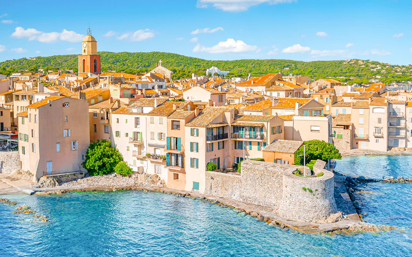 Saint-Tropez waterfront with historic buildings and bell tower, Provence, Cote d'Azur.