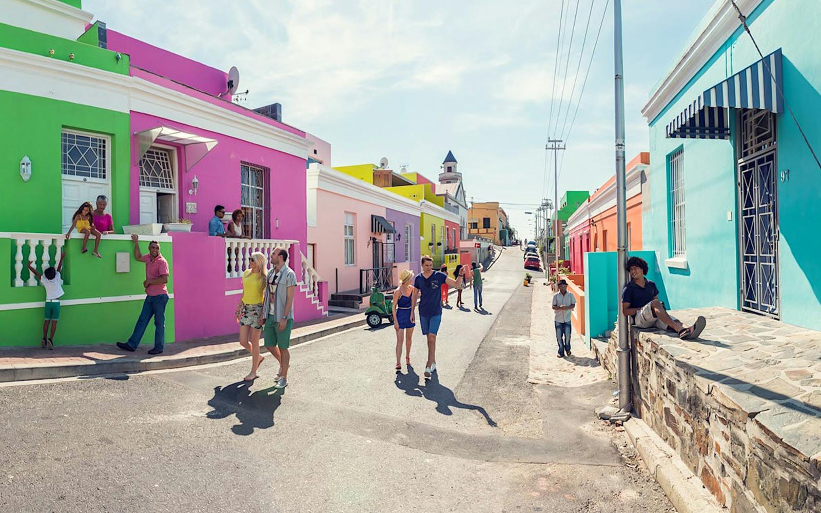 Colorful houses and people in Bo-Kaap neighborhood, Cape Town, South Africa.