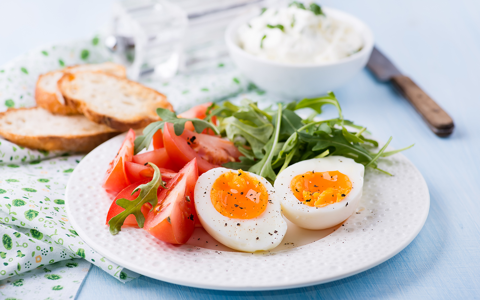 Soft boiled eggs served with tomatoes and lettuce