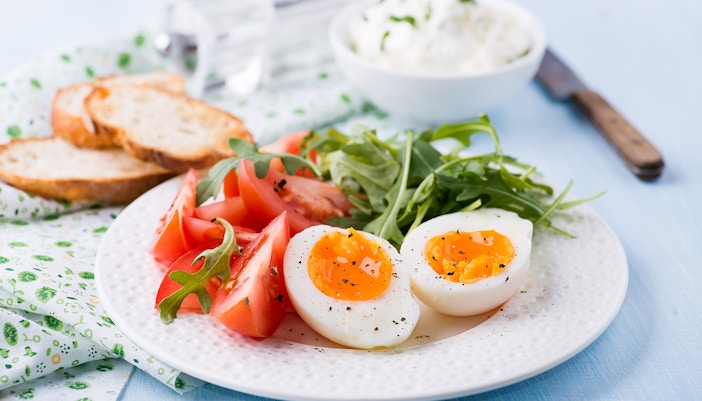 Soft boiled eggs served with tomatoes and lettuce