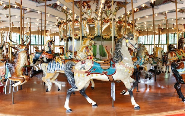 Carousel at San Francisco Zoo with ornate horse and deer figures.