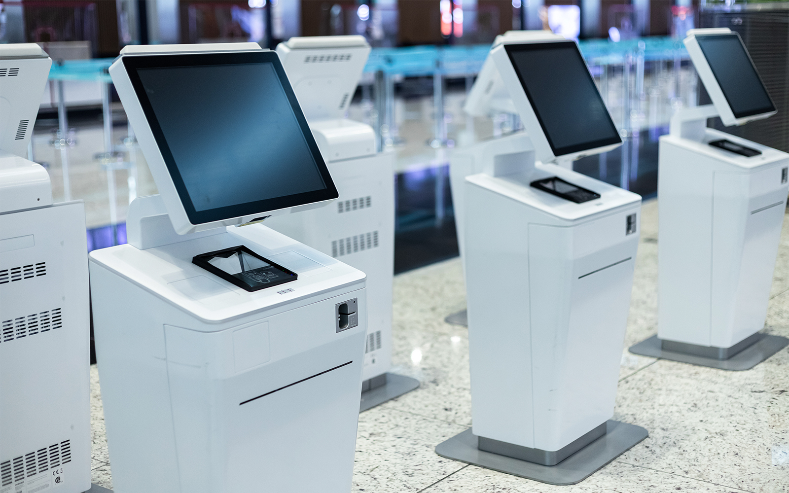 Self-service ticket kiosks in a modern facility.