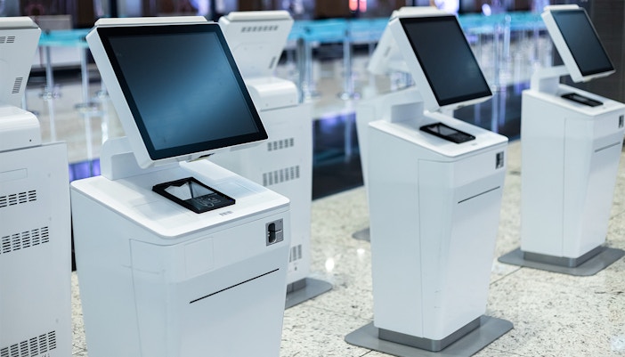 Self-service ticket kiosks in a modern facility.