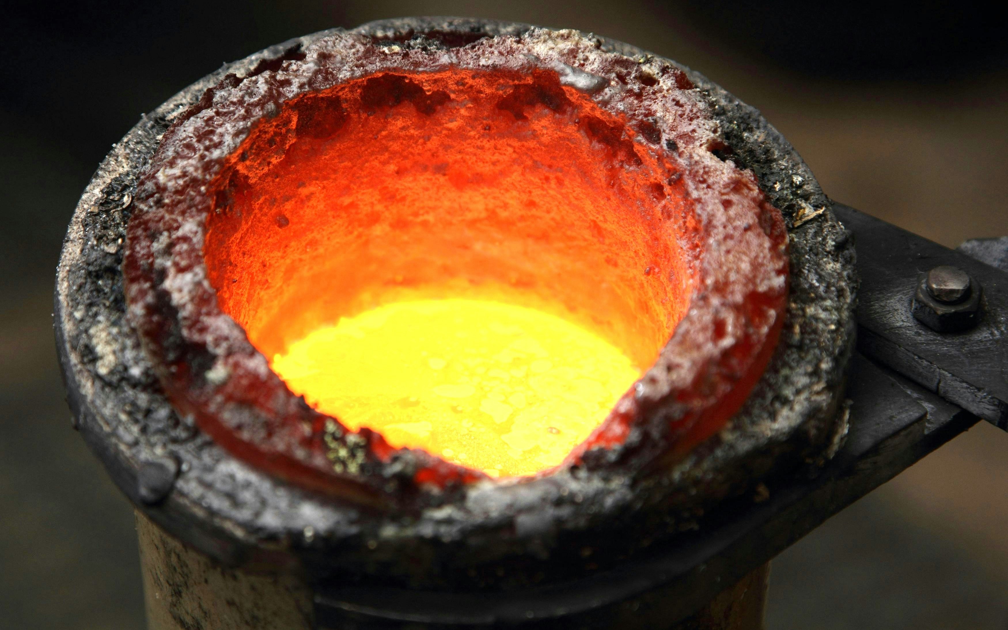 Molten gold in a crucible during a smelting process.