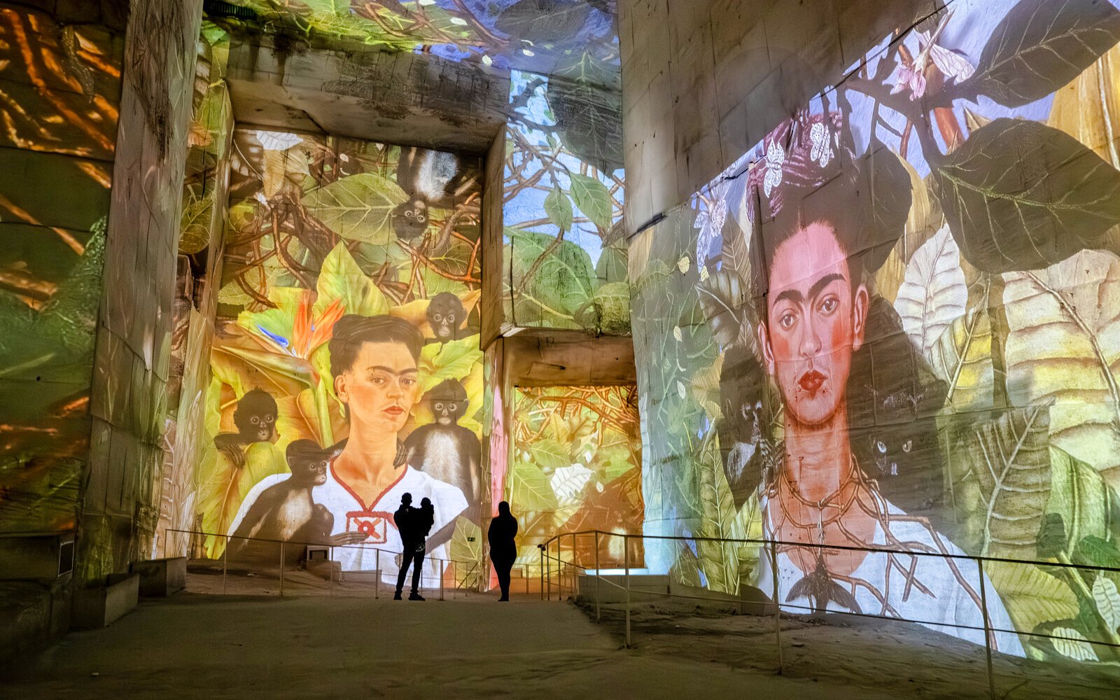 Frida Kahlo artwork projected at Carrières des Lumières exhibit, featuring vibrant jungle theme.