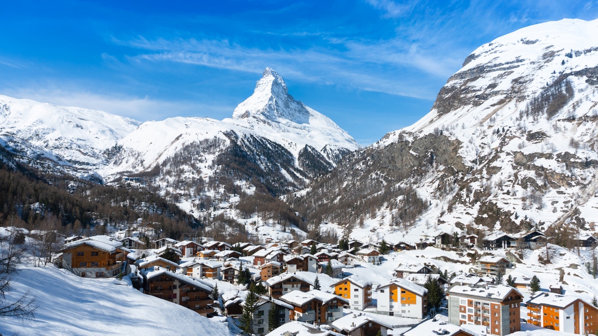 Zermatt village with snow-covered rooftops and Matterhorn mountain in the background, Switzerland.