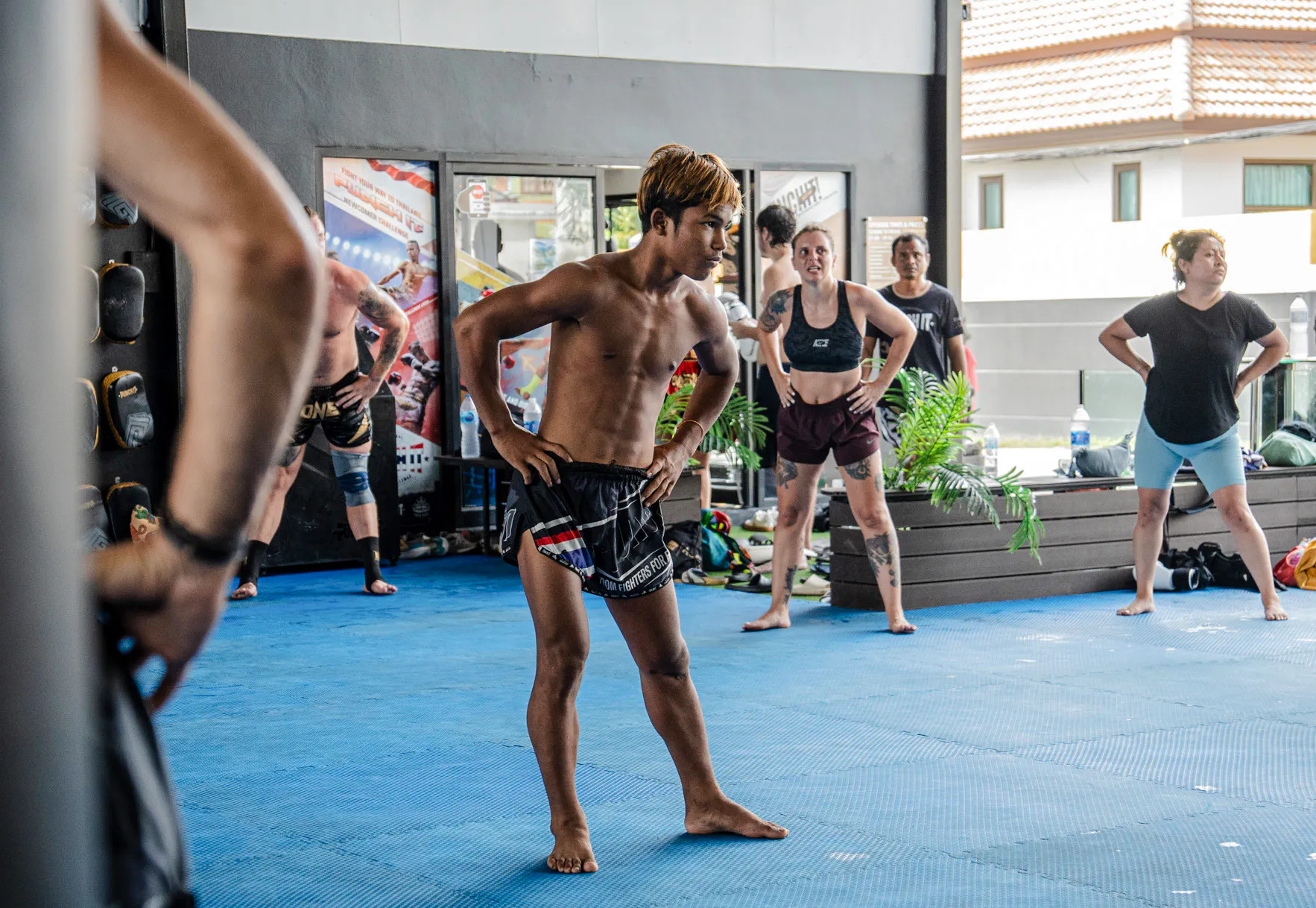 Beginners practicing Muay Thai boxing techniques in a Koh Samui training class.