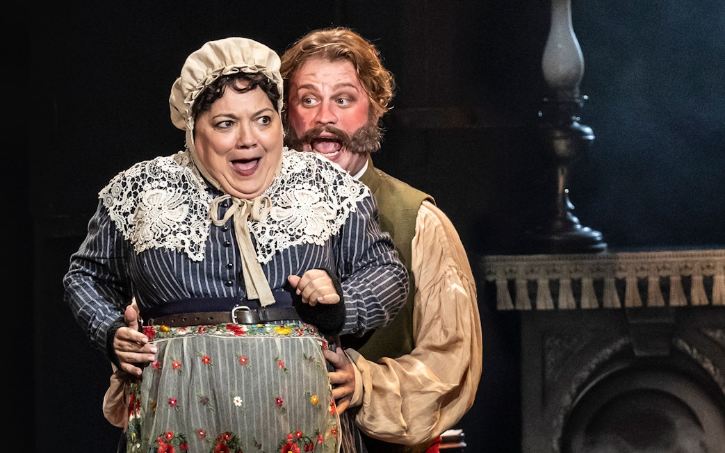 Actors performing a scene from the musical Oliver! on stage.