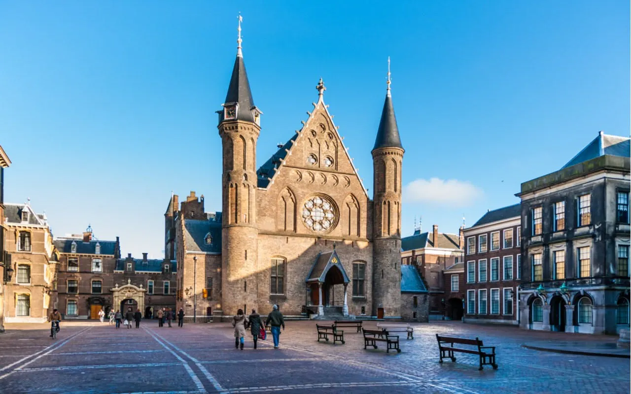 Binnenhof courtyard with Ridderzaal in The Hague, people walking.
