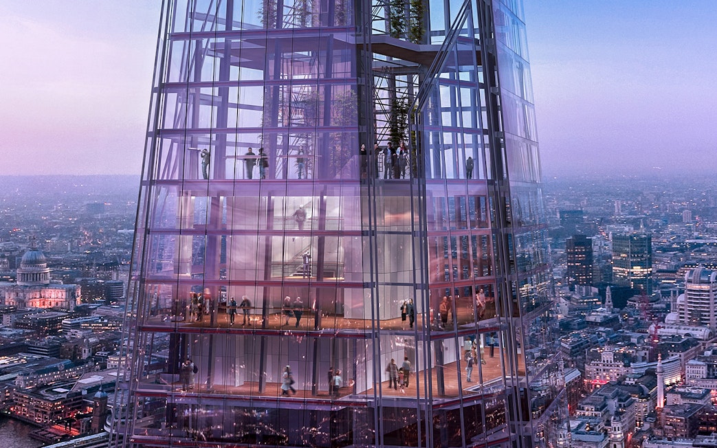 Visitors inside The Shard with panoramic views of London at dusk.