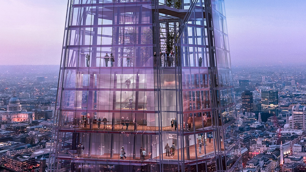 Visitors inside The Shard with panoramic views of London at dusk.