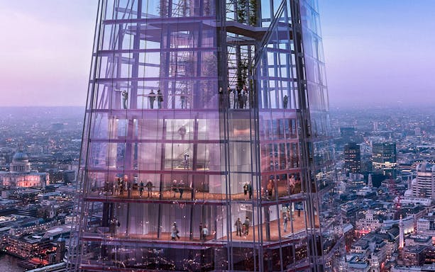 Visitors inside The Shard with panoramic views of London at dusk.