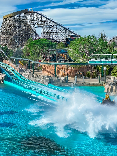 Blue Fire coaster loop with scenic backdrop and water splash at Europa-Park.
