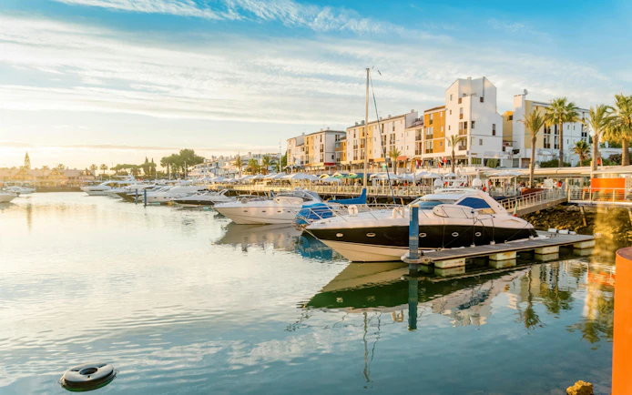Boats docked at Vilamoura marina in Quarteira, Algarve, Portugal.