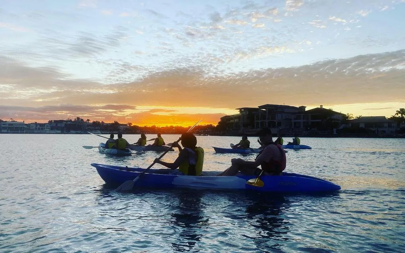 Kayakers paddling at sunset on Surfers Paradise tour, Gold Coast.