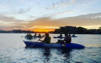 Kayakers paddling at sunset on Surfers Paradise tour, Gold Coast.