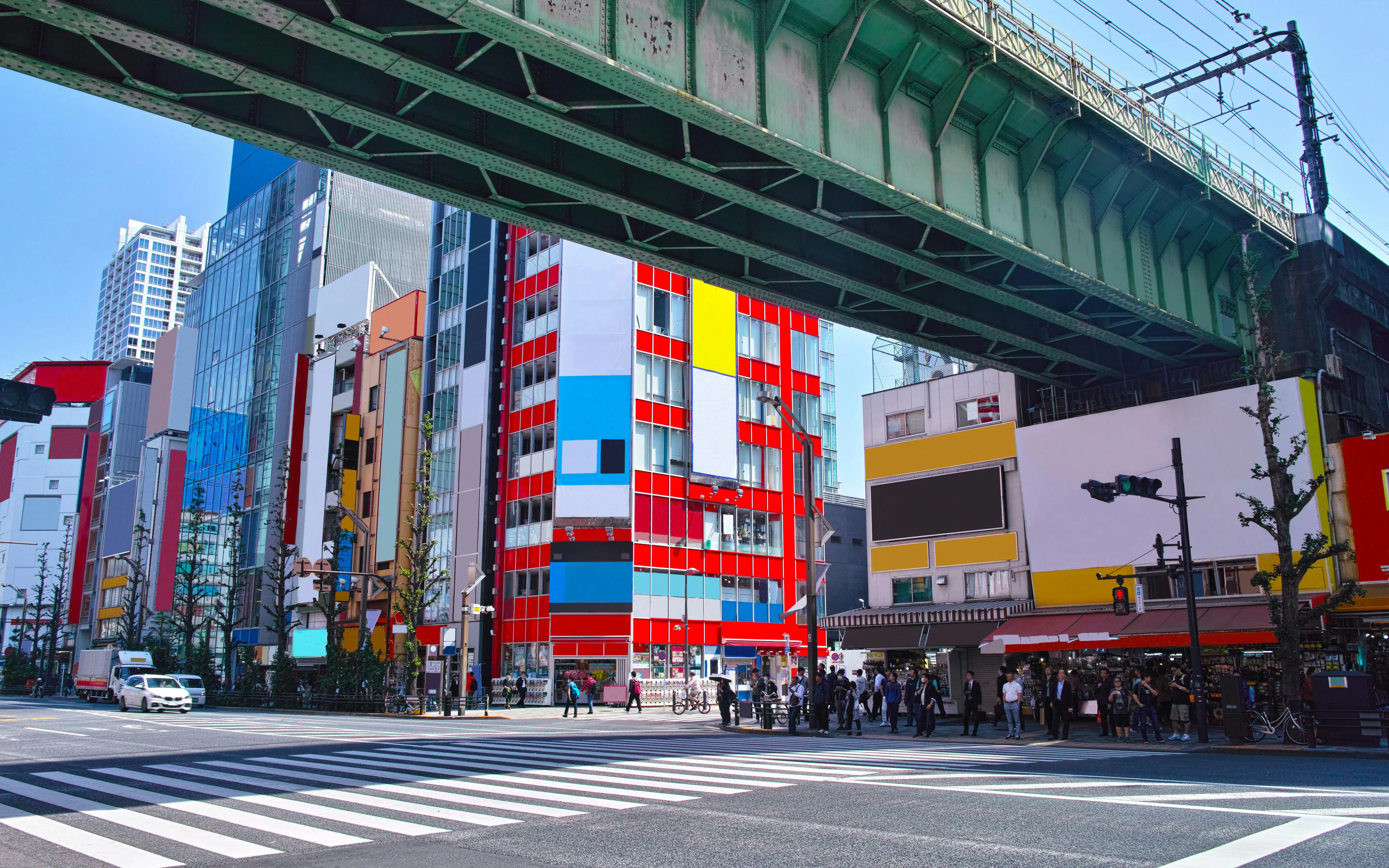 Akihabara Electric Town street view with colorful buildings and overhead railway, Tokyo.