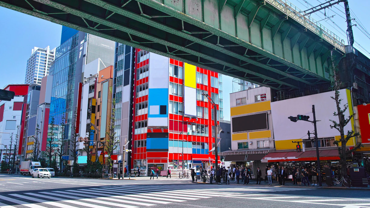 Akihabara Electric Town street view with colorful buildings and overhead railway, Tokyo.