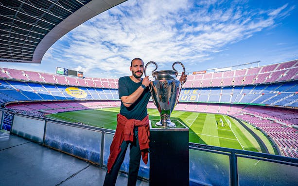 Person holding a trophy at Camp Nou stadium during FC Barcelona Players Experience Tour.