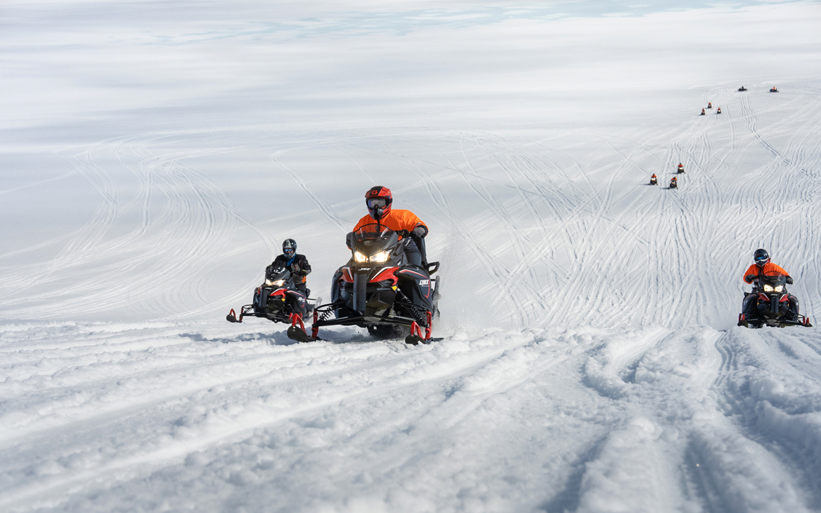 Snowmobilers riding on Langjökull Glacier in Iceland.