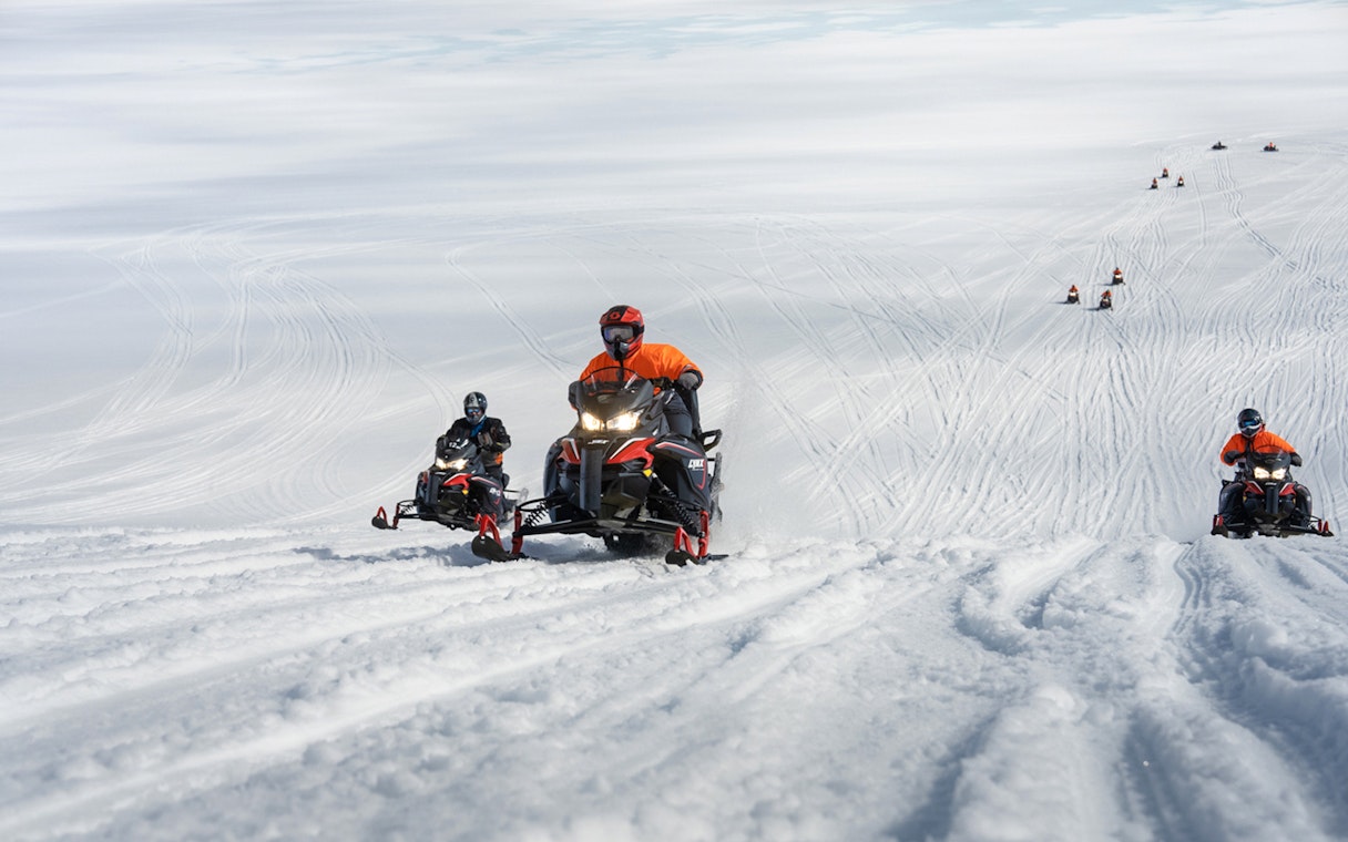 Snowmobilers riding on Langjökull Glacier in Iceland.