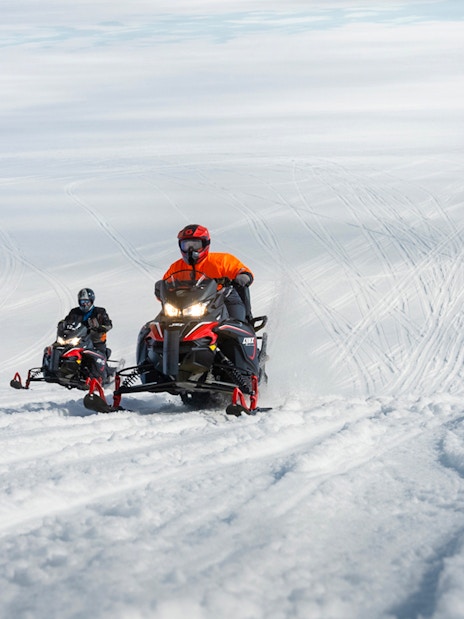 Snowmobilers riding on Langjökull Glacier in Iceland.