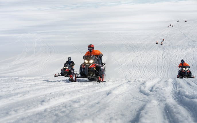 Snowmobilers riding on Langjökull Glacier in Iceland.