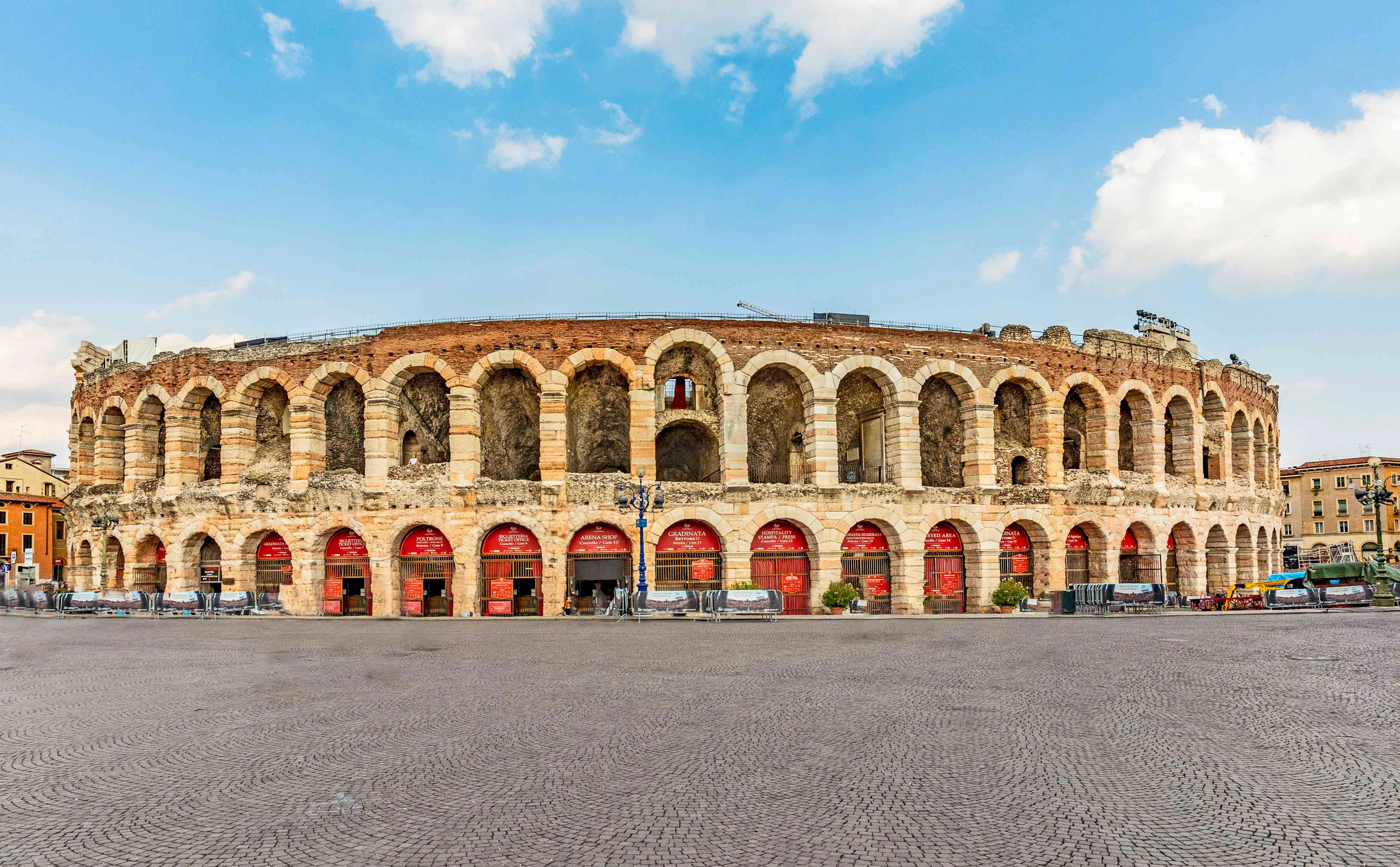 Verona Arena exterior with arches and stone facade in Verona, Italy.