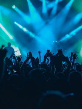 Crowd enjoying a concert with blue stage lights in Ushuaïa.