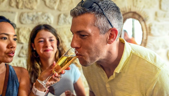 Participants try champagne on a Secret Food Tour in Paris