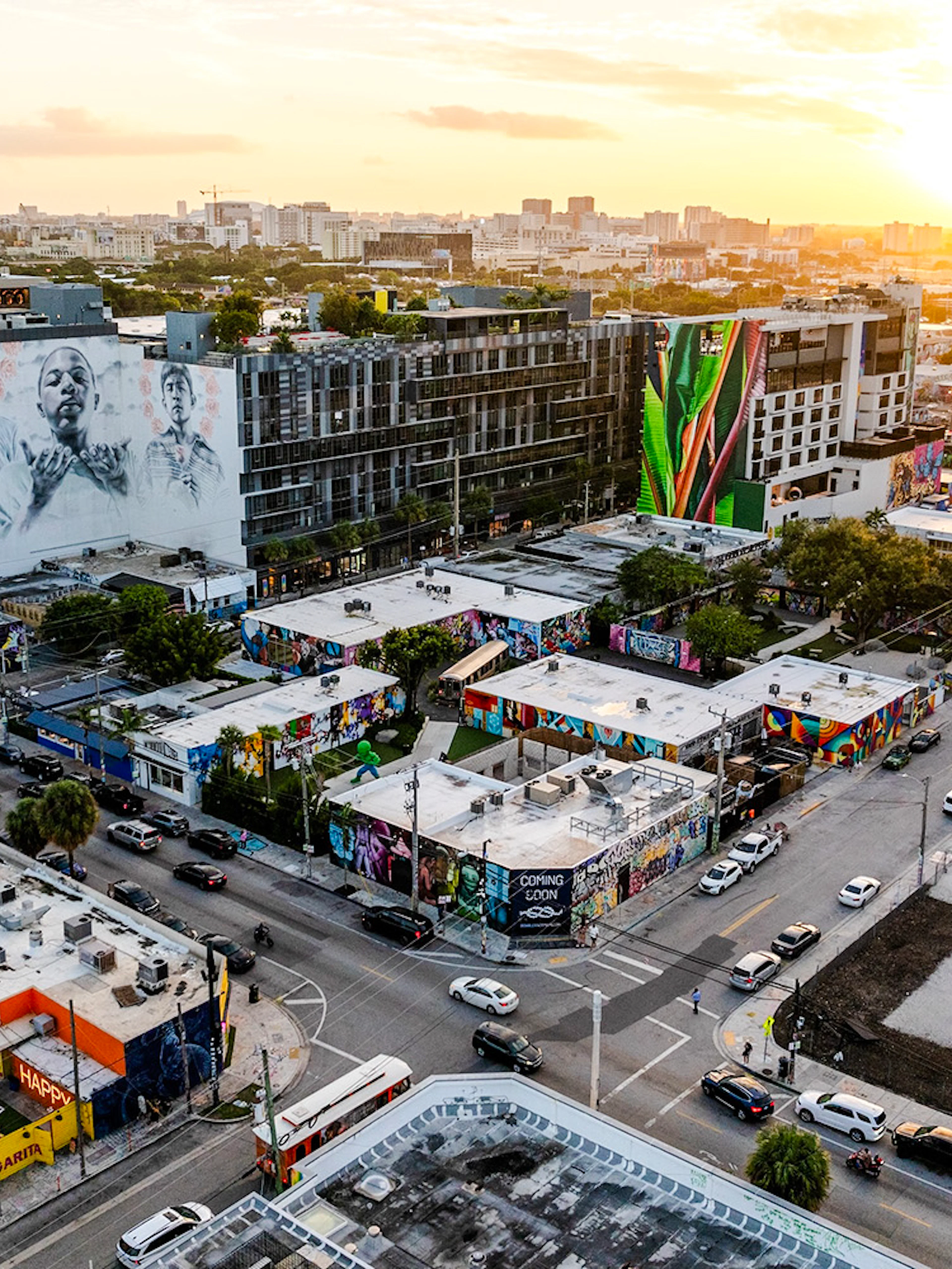 Aerial view of Wynwood Walls Museum in Miami featuring vibrant street art and murals at sunset.