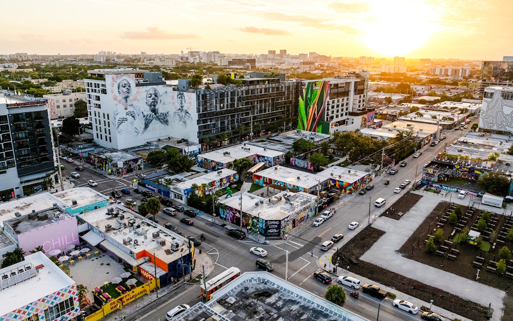 Aerial view of Wynwood Walls Museum in Miami featuring vibrant street art and murals at sunset.