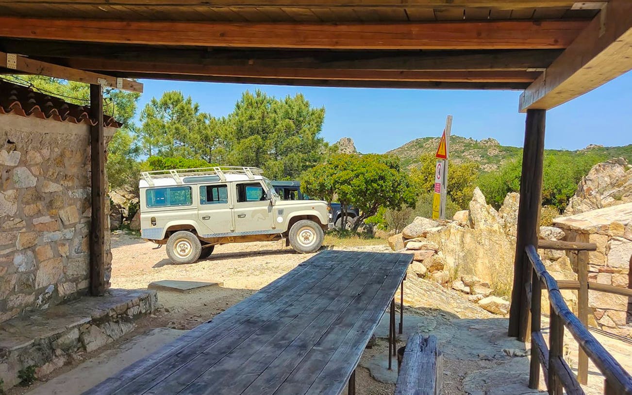 Jeep parked near rustic shelter on San Teodoro tour, Rio Pitrisconi trekking area.