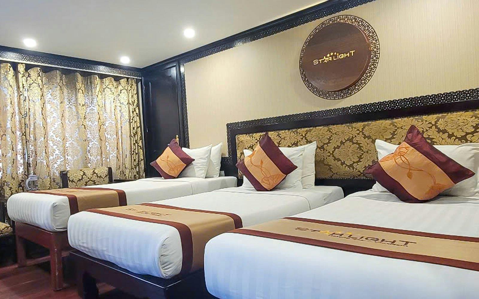 Luxurious twin beds in a 5-star cruise room, Halong Bay.