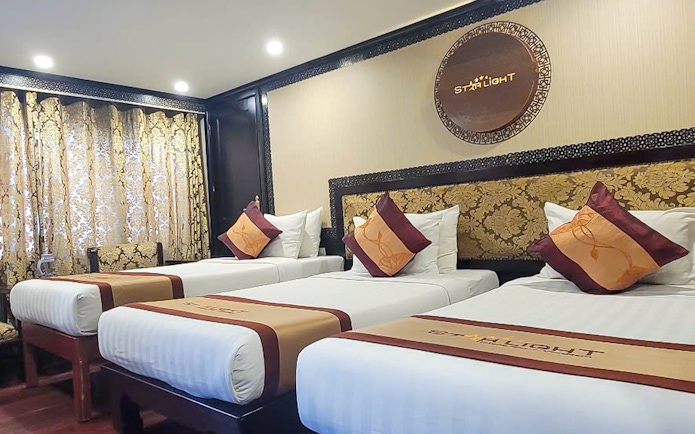 Luxurious twin beds in a 5-star cruise room, Halong Bay.