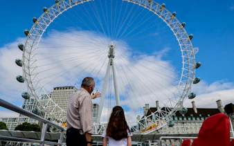 Guests viewing the London Eye from a cruise on the River Thames.