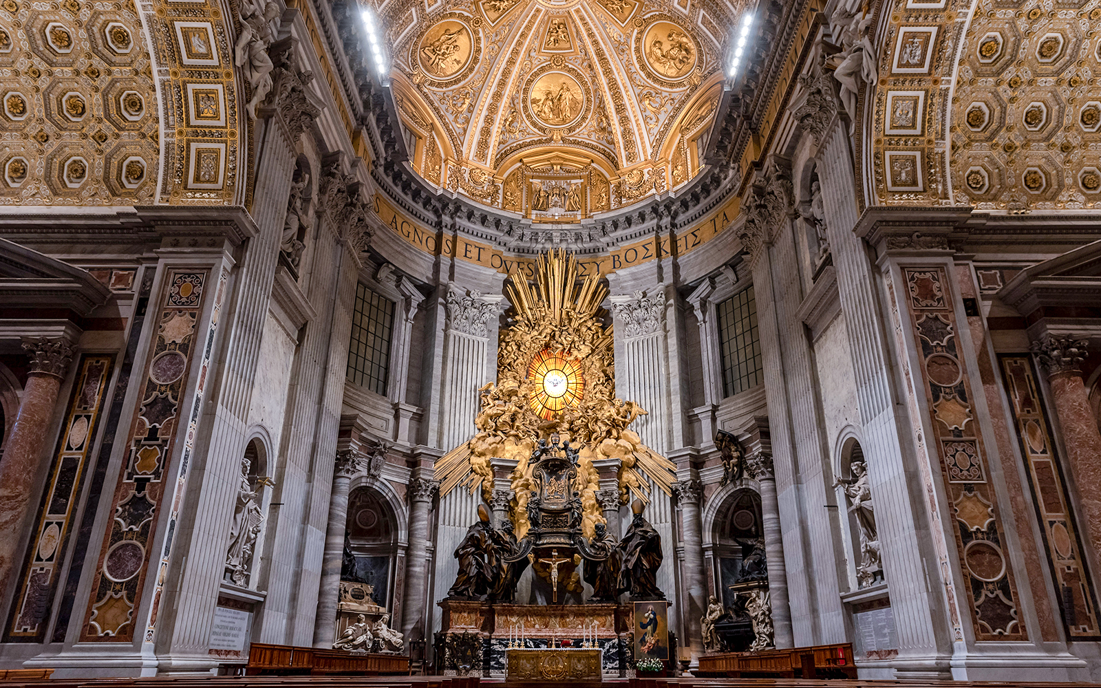 Altar of St. Peter's Basilica with ornate ceiling and sculptures, Vatican City.