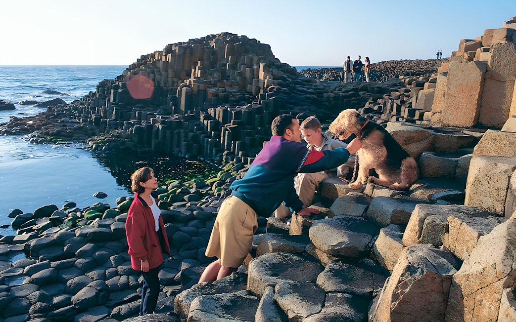 Visitors exploring Giant’s Causeway rock formations in Belfast.
