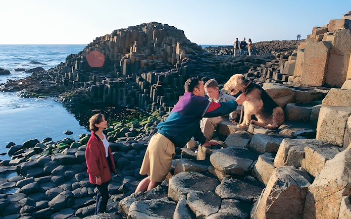 Visitors exploring Giant’s Causeway rock formations in Belfast.