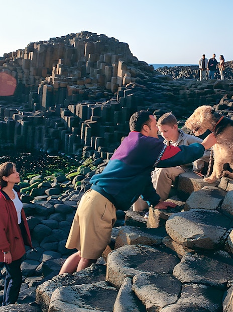 Visitors exploring Giant’s Causeway rock formations in Belfast.
