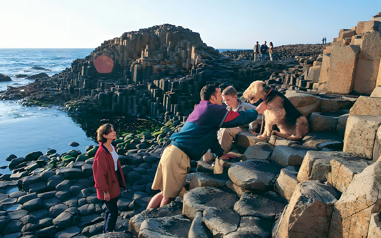 Visitors exploring Giant’s Causeway rock formations in Belfast.