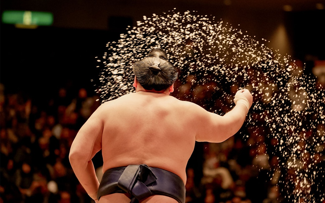 Sumo wrestler performing ritual at Tokyo tournament.