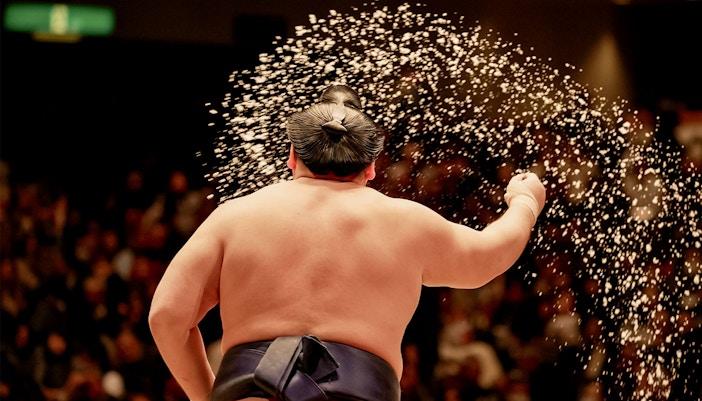 Sumo wrestler performing ritual at Tokyo tournament.