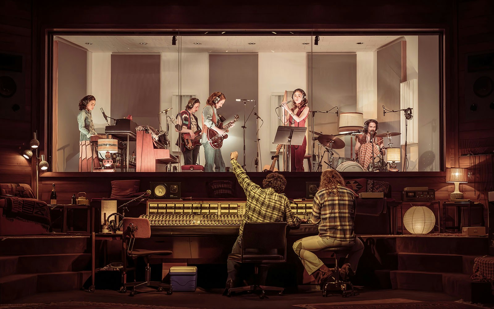 Recording studio session with musicians performing and engineers at the mixing console, Stereophonic tour.